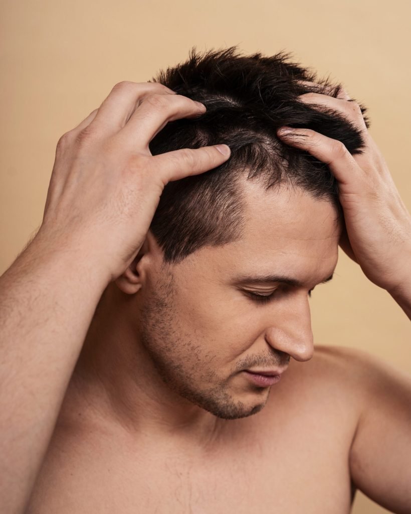 medium-shot-man-giving-himself-scalp-massage